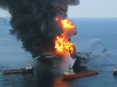 The burning Deepwater Horizon oilrig after an explosion caused by a design failure in the blowout preventer